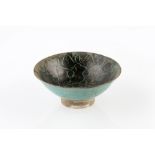 A Persian (Iran) bowl 12th/13th Century of black sepia slip with turquoise interlaced designs, 20.