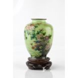 A Japanese plique a jour enamel vase Meiji period of ovoid form decorated with a rock formation upon