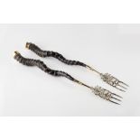 A pair of Siamese brass and horn forks early 20th Century the tops mounted with a shiva,