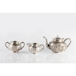 A Chinese three piece silver tea service circa 1900 decorated with bamboo handles, the centre of the