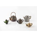 Four Chinese enamel teapots 19th/20th Century and a Chinese Paktong hexagonal teapot with green