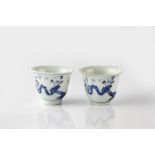 A pair of Doucai miniature wine cups 19th Century decorated flowering branches interspersed with