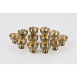 Twelve silver gilt Turkish Zarf bowls 19th century each with a splayed foot, pierced coat of arms