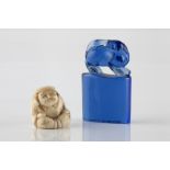 A Chinese blue Peking glass seal 19th Century 5cm and a Japanese netsuke in the form of Daikoku,