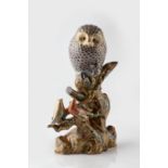 A Japanese Kutani porcelain sculpture of an owl and two song birds Meiji period decorated with