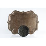 A Persian brass tray of pointed form with engraved pictorial scenes and surrounding river, 53cm,