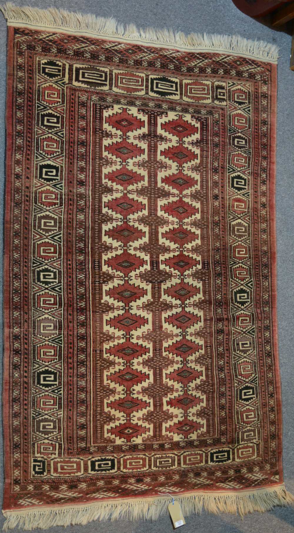 An Afghan rug with central medallion and geometric border, 201cm x 130cm