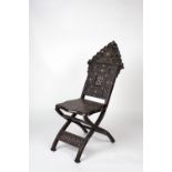 A Middle-Eastern hardwood folding chair 19th century with geometric bone inlay and carved