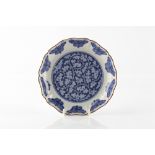 A Japanese Kakiemon style blue and white dish late 17th Century decorated with circular panels and
