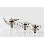 An Indian Tanjore three piece silver teaset to include a pot, jug and teapot, each of octagonal form