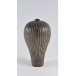 A Japanese bronze vase Meiji period of inverted baluster form with ribbed decoration, 24.5cm high