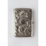 A Chinese silver folding cigar case with embossed dragon and clouds to one side, the reverse with
