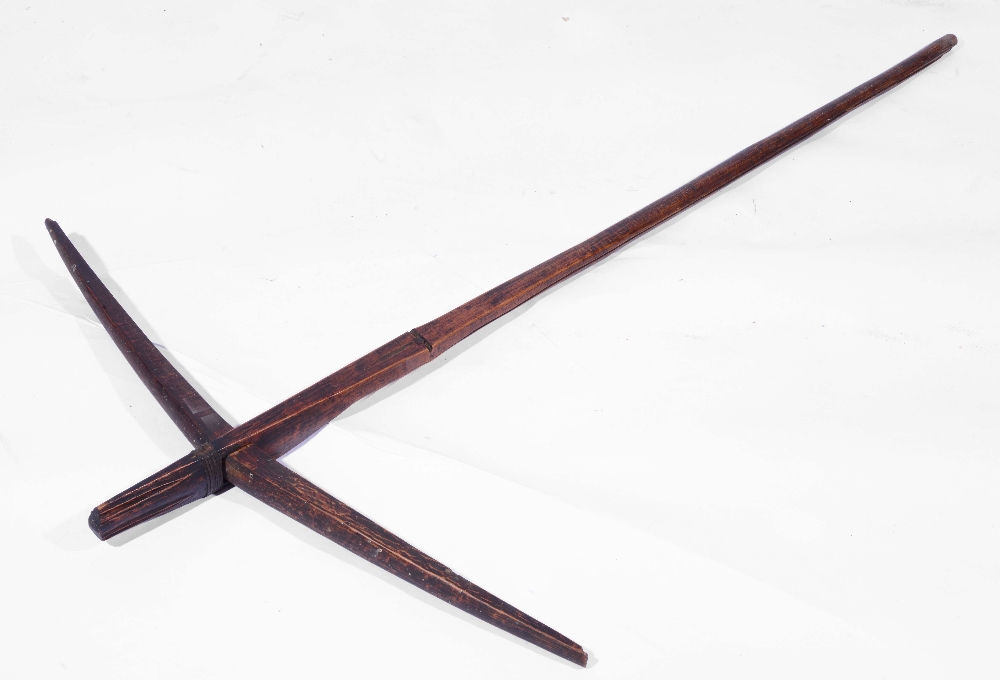 A WEST AFRICAN, GABON, FANG TRIBE WOODEN CROSSBOW with chamfered edge and leather strap work,