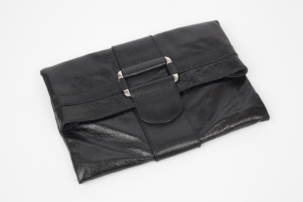 A high-shine black Alexander McQueen clutch bag with buckle detail to front flap and magnetic