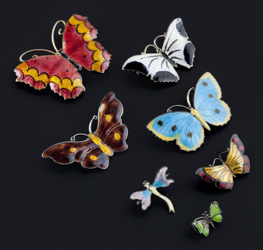 A collection of enamel butterfly and panel brooches, comprising six vari-coloured enamel butterfly