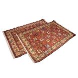 A MATCHED PAIR OF IRANIAN PART SILK RUGS, each decorated with repeated stylised cockerel motifs,