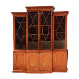 A 19TH CENTURY, SHERATON STYLE, SATINWOOD BREAK FRONT LIBRARY BOOKCASE the upper half having an