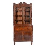 A GEORGE IV MAHOGANY SECRETAIRE BOOKCASE the upper half with break arch pediment, three adjustable