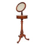 A VICTORIAN MAHOGANY GENTLEMANS SHAVING STAND with circular mirror, hinged lids and on fluted column