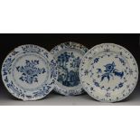 A GROUP OF THREE DUTCH DELFT BLUE AND WHITE PLATES each with foliate decoration, 36cm and 35cm