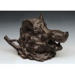 A PATINATED BRONZE INKWELL modelled as the head of a wild boar, the jaws opening to reveal a