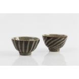 Edward Hughes (British, 1953-2006) Two tea bowls fluted ash glaze each impressed potter's seal