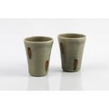 Edward Hughes (British, 1953-2006) Pair of beakers porcelain with celadon glaze and spotted iron