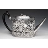 A GEORGE III SILVER TEAPOT with later embossed decoration and hardwood handle, London 1810 by George