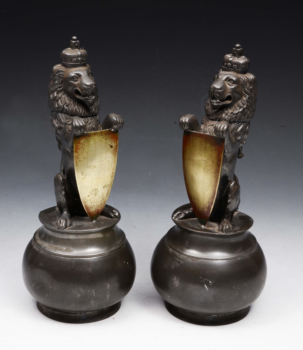 A PAIR OF VICTORIAN PEWTER SPOON WARMERS each in the form of an heraldic crowned lion, with