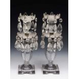 A PAIR OF REGENCY STYLE CUT GLASS CANDLESTICKS with facet cut drops and square bases, 27cm high (2)