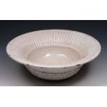 AN ITALIAN WHITE GLAZED FAIENCE BASIN with fluted rim, 36cm diameter