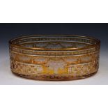 A BOHEMIAN AMBER GLASS OVAL BOWL with finely engraved basket of flowers and trailing floral swags