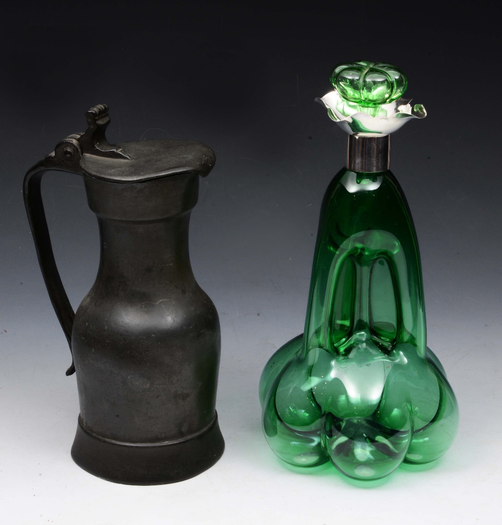 AN ANTIQUE PEWTER LIDDED JUG with makers mark L.C., 54cm high; together with a green glass and