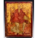 AN ORTHODOX RED AND GILT PAINTED ICON portraying a seated saint holding a Bible, perhaps St Paul,