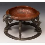 AN OSCAR BACH STUDIOS COPPER AND LEAD SMOKING STAND on four ram's mask headed and foliate capped