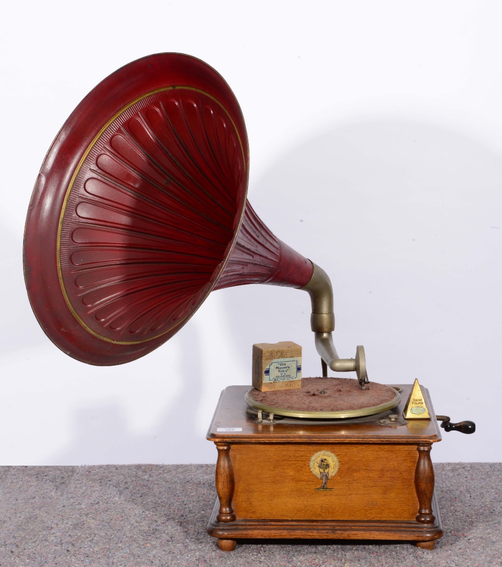 A WIND UP GRAMOPHONE with red lacquered horn and labelled 'Everything Under the Sun', registered