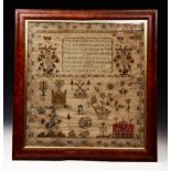 AN EARLY 19TH CENTURY SAMPLER, worked with a verse, flowers, houses, animals etc by Hannah