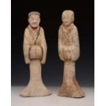 A PAIR OF CHINESE PAINTED POTTERY TOMB FIGURES, male and female subjects with flowing robes, 44cm
