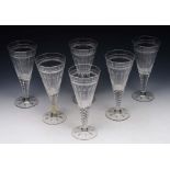 A SET OF SIX STUART DRINKING GLASSES with fluted tapering bowls, 21cm high