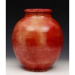 A MOORCROFT BRICK RED GLAZED BALUSTER VASE with ribbed body, 31cm high