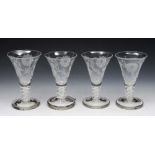 A SET OF FOUR JACOBEAN STYLE ALE GLASSES with engraved rose decoration and cotton twist stems,