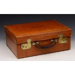 A TAN LEATHER DRESSING CASE by J W Benson Ltd, Ludgate Hill, London with brass locks, 43cm wide