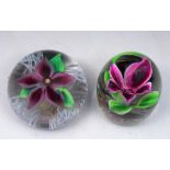 A HEAVY GLASS PAPERWEIGHT inset Clematis flower, 9cm diameter; and another similar, dumpy weight,