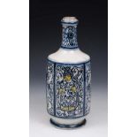 AN ANTIQUE CONTINENTAL FAIENCE BOTTLE with blue, white and yellow glaze alternating figure