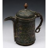 AN ISLAMIC ENGRAVED COPPER LIDDED JUG decorated with stylistic animal figures with shaped handle,