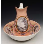 A 19TH CENTURY BLUSH GROUND PORCELAIN JUG AND BASIN decorated fishing scenes en grisaille within a