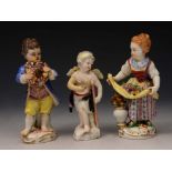 A MEISSEN FIGURE of a young boy and female companion, he with garland of flowers, she with flowers