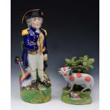 A STAFFORDSHIRE POTTERY RAM AND LAMB on an apple green ground bocage, 15cm high; and a Staffordshire