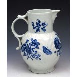 A WORCESTER BLUE AND WHITE PORCELAIN MASK JUG of large proportions with butterfly and flower