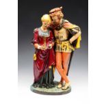 A VICTORIAN CAST IRON GROUP of Faust et Marguerite with painted decoration on an oval plinth, 43cm